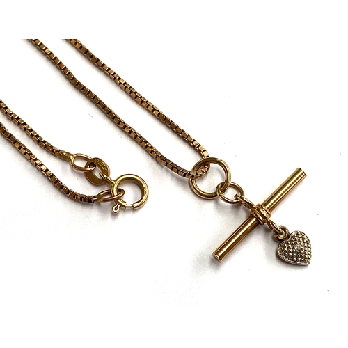 25 - A 9ct gold box link chain with a miniature T-bar pendant suspending a 9ct white gold heart set with ... 