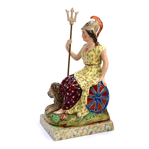 63 - A 19th century Staffordshire pearlware figure of Britannia, seated holding a trident and shield with... 