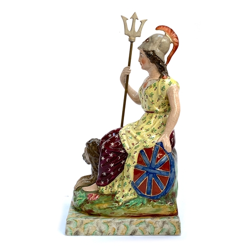 63 - A 19th century Staffordshire pearlware figure of Britannia, seated holding a trident and shield with... 