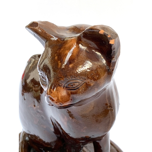 66 - A 19th century treacle glazed earthenware figure of a cat, possibly Canney Hill Pottery, 29cmH