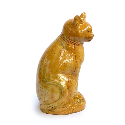 67 - A Welsh Claypits Ewenny pottery seated cat c.1900, in mustard glaze with incised detail, firing faul... 