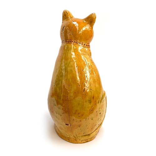 67 - A Welsh Claypits Ewenny pottery seated cat c.1900, in mustard glaze with incised detail, firing faul... 