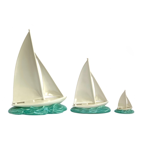 68 - A set three 1930s Poole Pottery graduating sailing boats, 39cmH,  26.5cm and 11cmH, the two smaller ... 