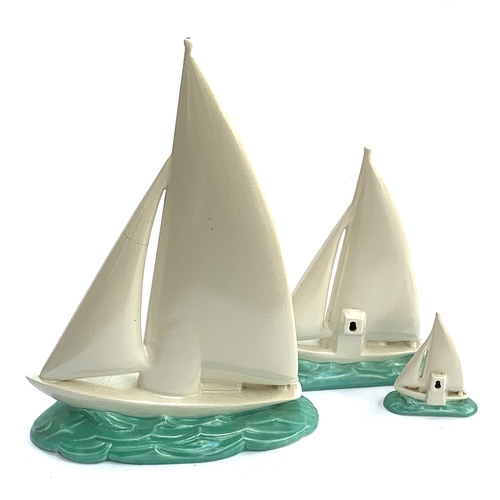 68 - A set three 1930s Poole Pottery graduating sailing boats, 39cmH,  26.5cm and 11cmH, the two smaller ... 