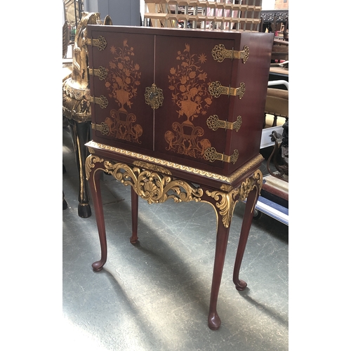 844 - A modern Chinoiserie style red stained drinks cabinet with mirrored interior on a carved parcel-gilt... 