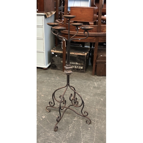 788 - A wrought iron floor standing candle holder with five sconces, 108cmH; together with a further wroug... 