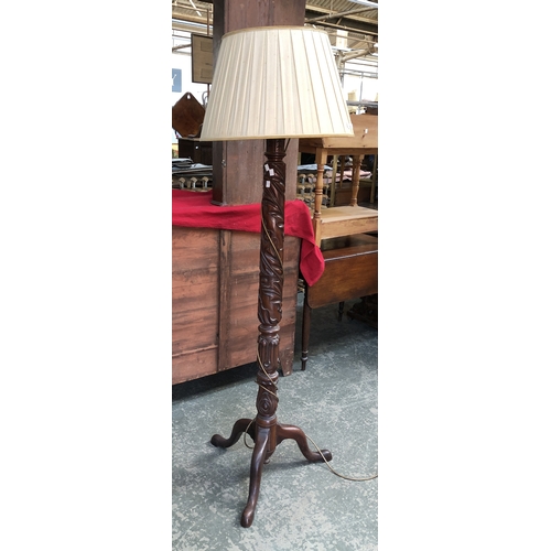 807 - A mahogany standard lamp, carved with acamthus and lotus motifs, on tripod cabriole base, 150cmH