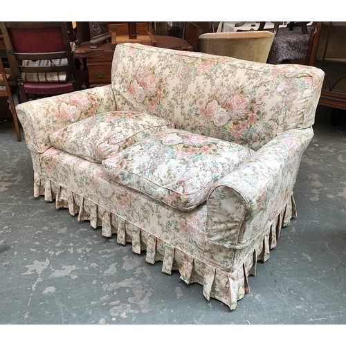 852 - An early 20th century two-seater sofa with feather cushions and floral sofas, 153cmW