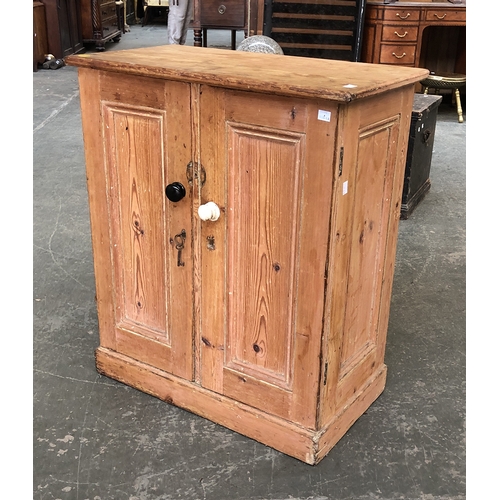 824 - A small 19th century pine cabinet with panel doors and sides, 67x36x76cmH