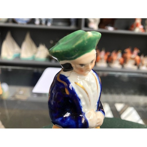 88 - Cricket interest: a small 19th century Staffordshire figure of a cricketer, labelled 'Rockingham' to... 