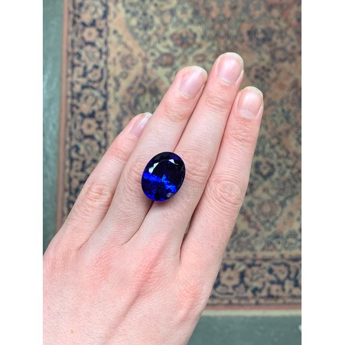 111 - A very large unmounted tanzanite, the oval mixed cut stone 32.18cts and measuring 22.32x17.45x11.63,... 