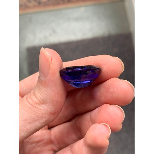 111 - A very large unmounted tanzanite, the oval mixed cut stone 32.18cts and measuring 22.32x17.45x11.63,... 