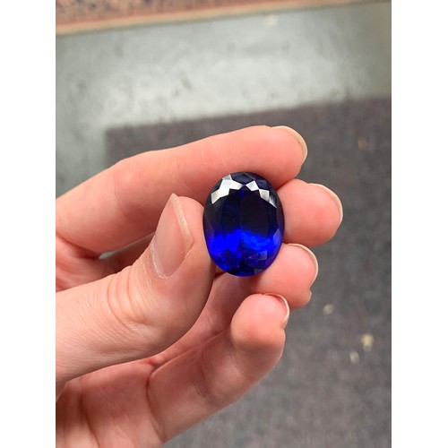 111 - A very large unmounted tanzanite, the oval mixed cut stone 32.18cts and measuring 22.32x17.45x11.63,... 