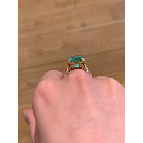 123 - A Kat Florence 18ct gold, emerald and diamond ring, the Muzo Colombian emerald 9.69cts and measuring... 