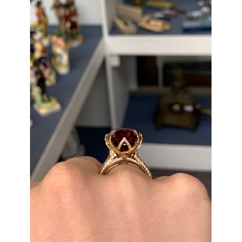 122 - A Kat Florence 18ct gold, red zircon and diamond ring, the natural red zircon 30.7cts and 20x4x14.3m... 