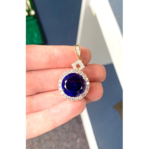 36 - An 18ct gold mounted large tanzanite pendant, the round brilliant cut stone measuring 16.5mmD and we... 