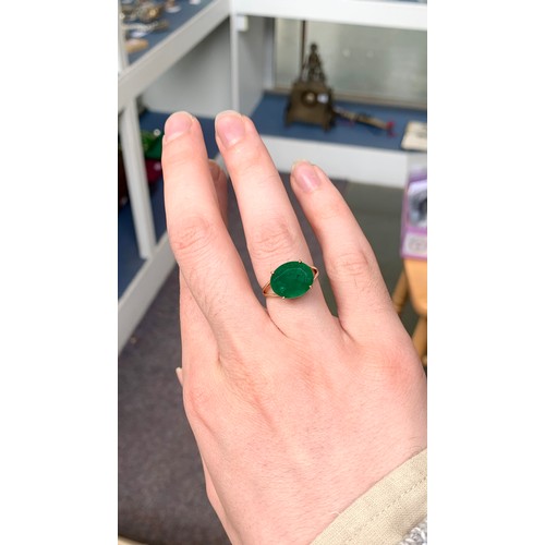 46 - A 9ct gold ring set with an oval cut Bahia emerald, approx 5.3cts, size N 1/2, 2.5g purchased by the... 