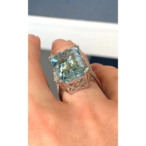 34 - An 18ct white gold mounted aquamarine and diamond ring, the emerald cut aquamarine weighing 19.71cts... 