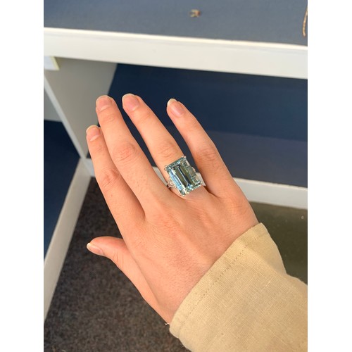 34 - An 18ct white gold mounted aquamarine and diamond ring, the emerald cut aquamarine weighing 19.71cts... 