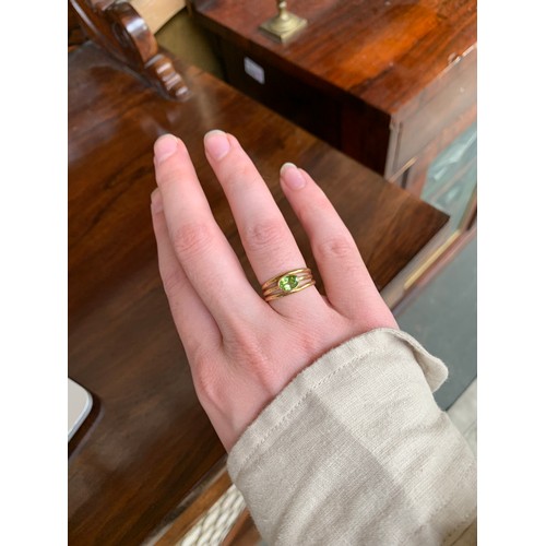 25 - An 18ct gold and peridot ring with a trifurcated style band, size O, gross weight 5.5g