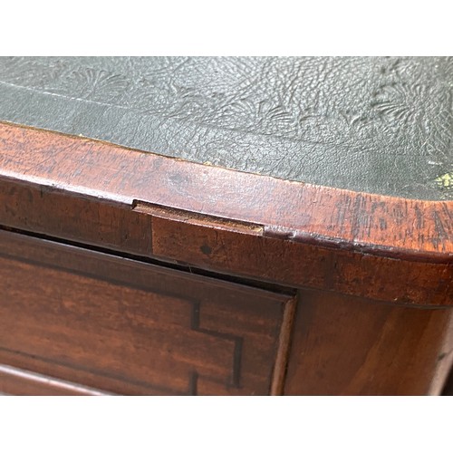 410 - A Regency mahogany library table, the rectangular top with re-entrant corners, inset tooled leather ... 