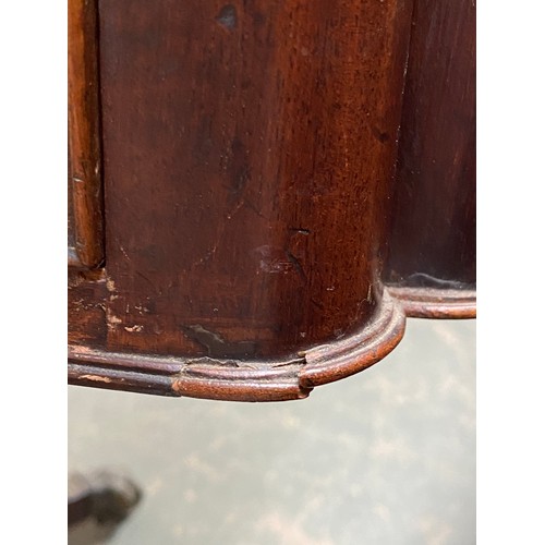 410 - A Regency mahogany library table, the rectangular top with re-entrant corners, inset tooled leather ... 