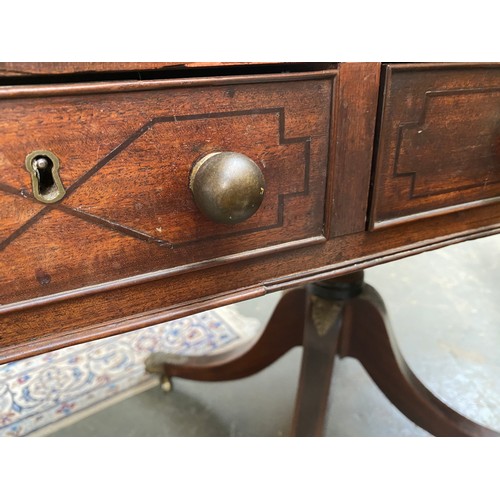 410 - A Regency mahogany library table, the rectangular top with re-entrant corners, inset tooled leather ... 