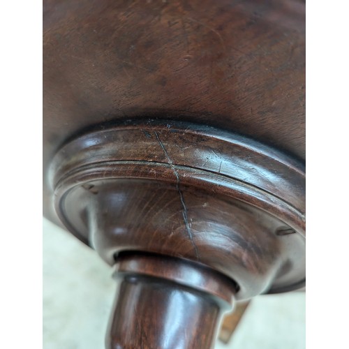 392 - A George III mahogany wine table, the circular dished top raised on a baluster turned column, and tr... 