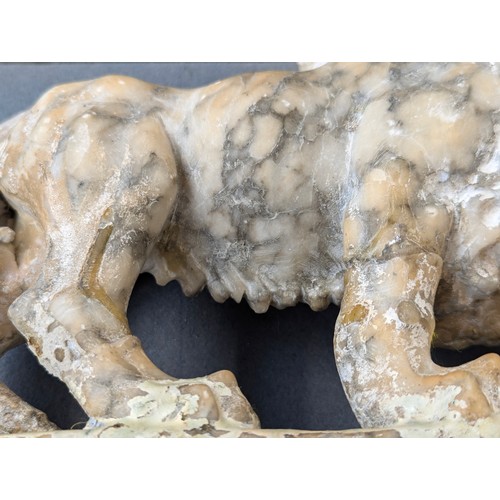 234 - A pair of carved marble sculptures in the form of Medici lions with orbs, 24cm long

Provenance: pri... 