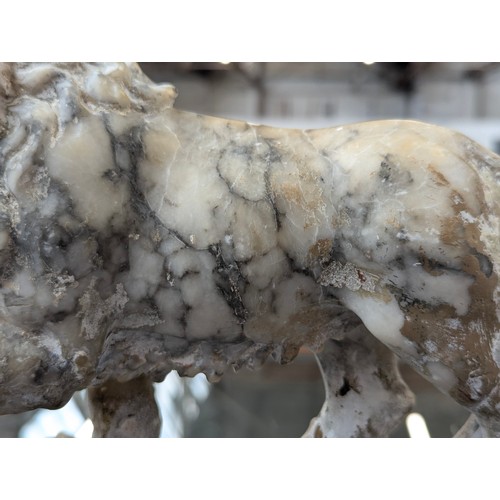 234 - A pair of carved marble sculptures in the form of Medici lions with orbs, 24cm long

Provenance: pri... 