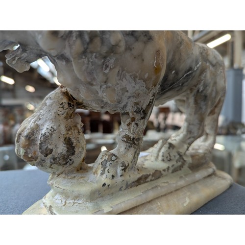 234 - A pair of carved marble sculptures in the form of Medici lions with orbs, 24cm long

Provenance: pri... 