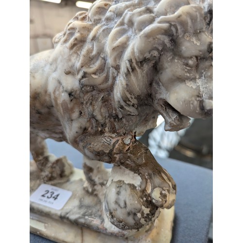 234 - A pair of carved marble sculptures in the form of Medici lions with orbs, 24cm long

Provenance: pri... 