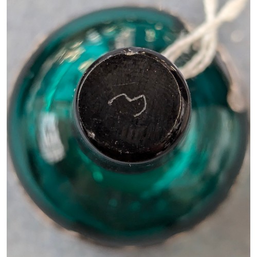 253 - An early 20th century green glass silver mounted dressing table bottle, marked 'Sterling', 11cm high