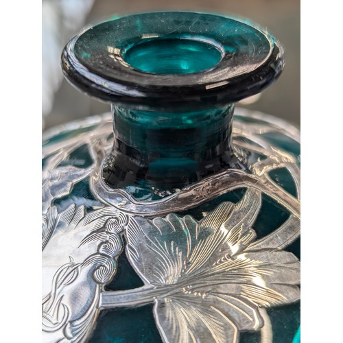 253 - An early 20th century green glass silver mounted dressing table bottle, marked 'Sterling', 11cm high