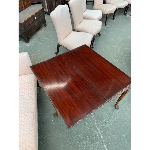 396 - An 18th century mahogany card table, the foldover top with gadrooned edge, over a blind fretwork fri... 