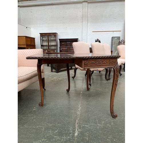 396 - An 18th century mahogany card table, the foldover top with gadrooned edge, over a blind fretwork fri... 