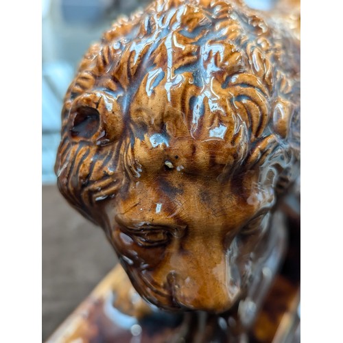 241 - A 19th century Staffordshire treacle glazed Medici lion, 22cm high

Provenance: private collection, ... 