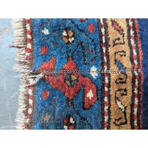 465 - A blue ground Persian rug, 193x124cm