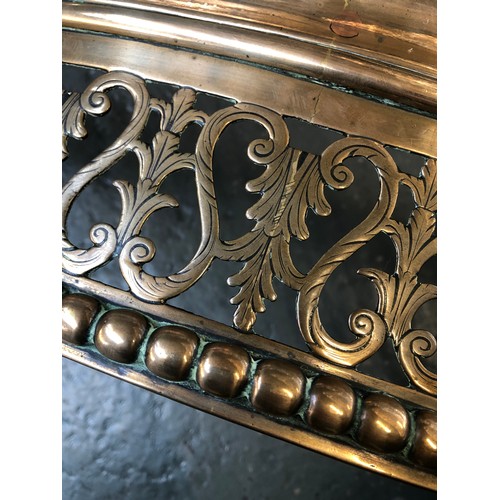 351 - A George III serpentine brass fender, c.1800, the pierced front with scroll and trailing bell flower... 