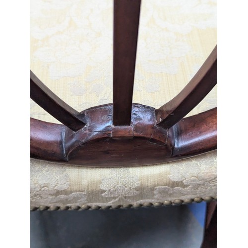 445 - A set of five George III Hepplewhite style mahogany side chairs, two carvers, the shield backs above... 