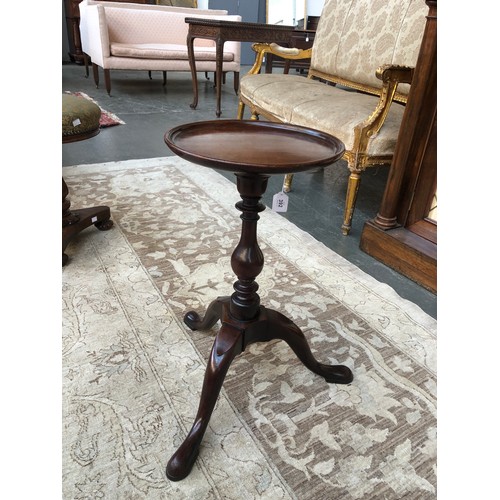 392 - A George III mahogany wine table, the circular dished top raised on a baluster turned column, and tr... 