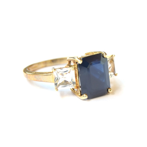 1 - A 9ct gold, sapphire and goshenite ring, the emerald cut sapphire 4.3cts, size N 1/2, 3.5g