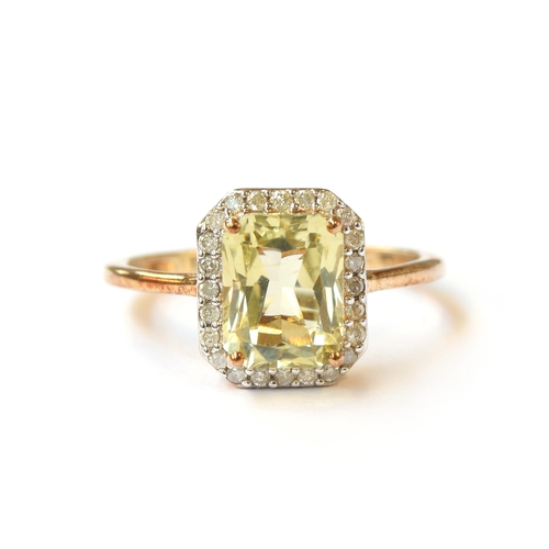 3 - A 9ct gold ring set with hiddenite surrounded by diamonds, the octagonal hiddenite approx. 2.9cts, s... 