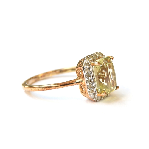 3 - A 9ct gold ring set with hiddenite surrounded by diamonds, the octagonal hiddenite approx. 2.9cts, s... 