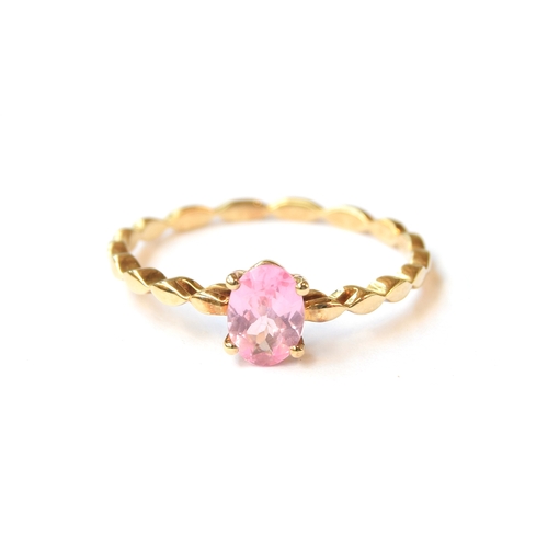 44 - A 10ct gold pink spinel solitaire ring with wavy band, the spinel 0.79cts. size S, 1.6g