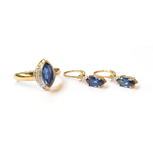 5 - A 9ct gold ring set with a marquise cut Burmese sapphire, 1.87cts, surrounded by white sapphires, si... 