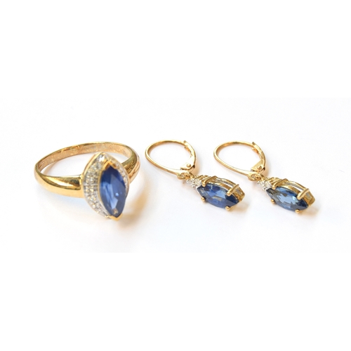 5 - A 9ct gold ring set with a marquise cut Burmese sapphire, 1.87cts, surrounded by white sapphires, si... 