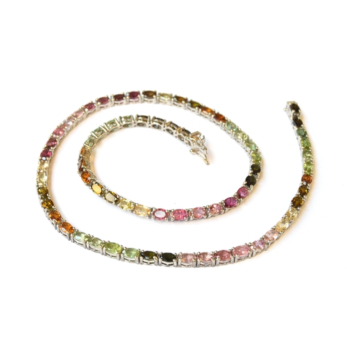 50 - A sterling silver necklace set with a rainbow of tourmalines, the 71 oval tourmalines totalling 32ct... 