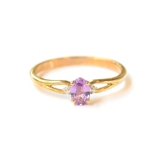 9 - A 9ct gold ring set with a purple sapphire and white natural zircons, the sapphire 0.5cts, size R 1/... 