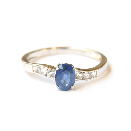 54 - A 14ct white gold ring set with a sapphire and three channel set white sapphires, the blue Kanchanab... 